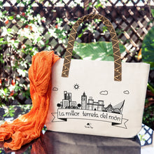 Cargar imagen en el visor de la galería, Bolso tote blanco con asas de cinta tejida beige y negra, estampado de Valencia “La millor terreta del món”
